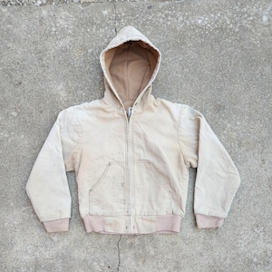 May include: A light beige hooded jacket with a zipper closure. The jacket has a relaxed fit and a slightly distressed look.