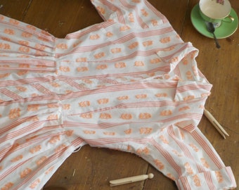 May include: A white and peach striped dress with a floral pattern. The dress has long sleeves and a button-up front.