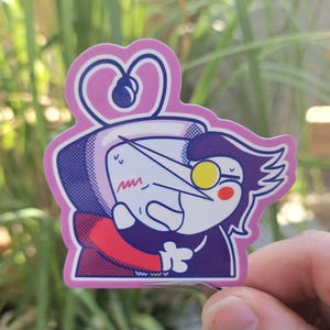 May include: A sticker featuring a cartoon character in a hug. The character has a white face, a long nose, and a yellow monocle. The character is wearing a purple suit and a red jacket. The sticker has a pink border with a heart design.