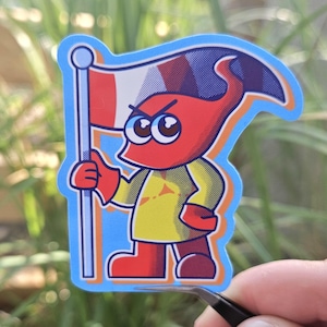 Puede incluir: Una pegatina con un personaje de dibujos animados rojo con una camisa amarilla, sosteniendo una bandera con rayas rojas, blancas y azules. El personaje tiene una expresión enfadada. La pegatina tiene un borde azul.
