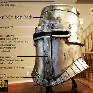 May include: A silver helmet with a detailed design, including a nose guard, eye slits, and a back vertical guard. The helmet is labeled with the text "top helm front back" and "Nose guard T".