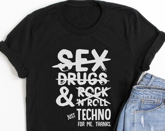 May include: Black t-shirt with white text that reads "SEX, DRUGS & ROCK 'N' ROLL" with lines through each word, and "JUST TECHNO FOR ME, THANKS." The shirt is paired with denim shorts.
