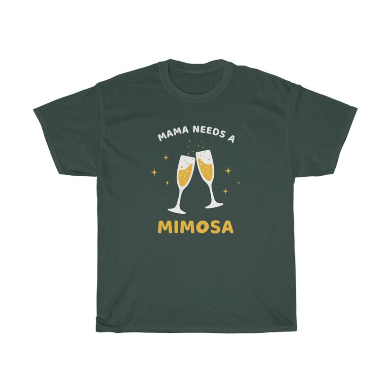 May include: Dark green t-shirt with the text "MAMA NEEDS A MIMOSA" in white and yellow. The design features two champagne flutes with bubbly liquid and star accents. A casual, comfortable tee.