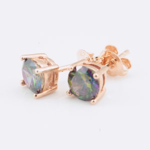 May include: A pair of rose gold stud earrings with iridescent round gemstones.