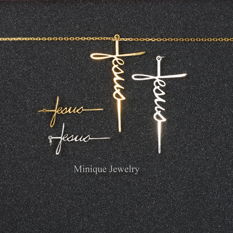 May include: Two gold and silver Jesus cross pendants with a gold chain. The pendants are in the shape of a cross with the word "Jesus" written in cursive.