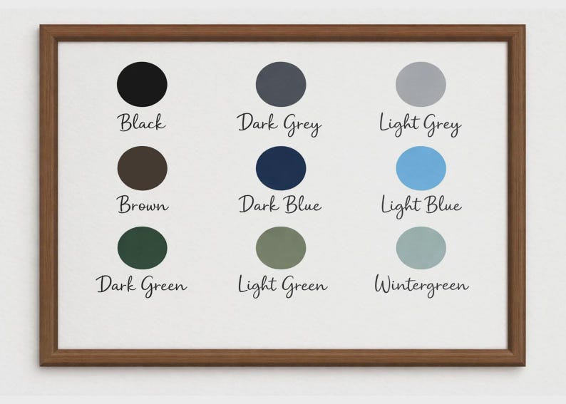 May include: A framed print featuring a color palette with nine color swatches. The colors include black, dark grey, light grey, brown, dark blue, light blue, dark green, light green, and wintergreen. Each color is labeled.