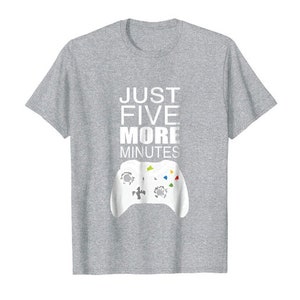 May include: A heather grey t-shirt with the text "Just Five More Minutes" in white and a white video game controller graphic.