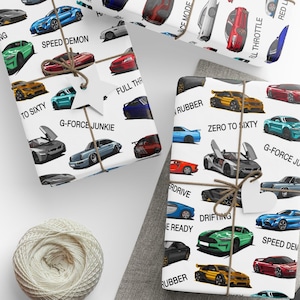 a pair of scissors next to wrapping paper with cars on it