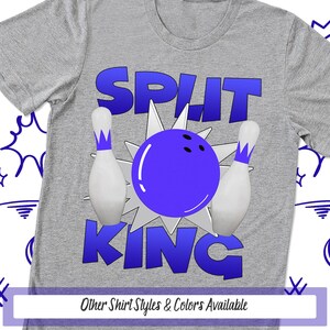 May include: A heather gray t-shirt featuring a graphic of a purple bowling ball striking white bowling pins. The text SPLIT KING is printed in large blue letters above and below the graphic. The design includes a white starburst shape.