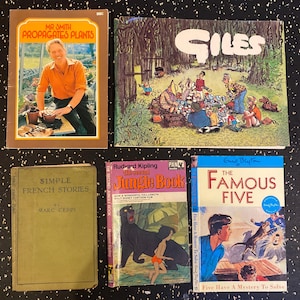 May include: A collection of five vintage paperback books. The books are all different colors and have different titles. The titles include "Mr. Smith Propagates Plants", "Giles", "The Second Jungle Book", "Simple French Stories", and "The Famous Five".