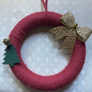Maroon yarn wreath with holiday accents