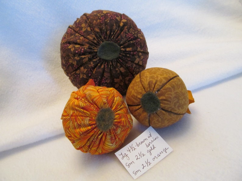 A Set of Three Fabric Pumpkins for the Autumn One Bright Orange Pumpkin One Gold on Gold Pumpkin One Large Brown with Berries Pumpkin