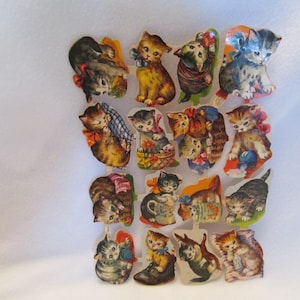 May include: A set of 18 vintage paper stickers featuring adorable kittens in various poses. The stickers are printed on thick paper and have a glossy finish. The kittens are depicted in a variety of colors, including brown, black, white, and gray. Some of the kittens are wearing bows or collars, and others are holding objects such as balls of yarn, baskets, and milk jugs.
