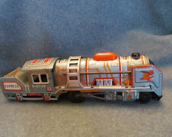 May include: A silver and orange toy train with the words "EXPRESS" and "C-0732" printed on the side. The train has a red and orange smoke stack and a black wheel.