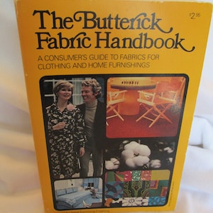 May include: A yellow book titled "The Butterick Fabric Handbook: A Consumer's Guide to Fabrics for Clothing and Home Furnishings" with a price of $2.95. The cover features a collage of images including a couple, cotton bolls, a living room, and various fabric swatches.
