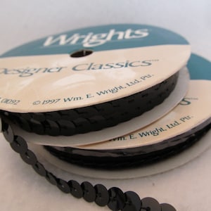 May include: Two spools of black sequined trim with the Wrights Designer Classics label. The label includes the text "©1997 Wm. E. Wright, Ltd. Pur."