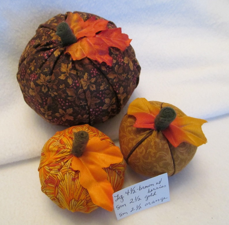 A Set of Three Fabric Pumpkins for the Autumn One Bright Orange Pumpkin One Gold on Gold Pumpkin One Large Brown with Berries Pumpkin
