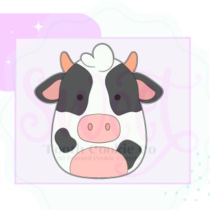 May include: A cartoon cow cookie cutter with black and white spots. The cow has a pink nose and large black eyes.