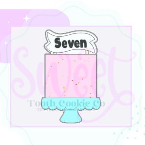 May include: A pink and white cake with gold sprinkles and a banner that says "Seven" on top. The cake is on a blue pedestal.