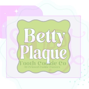 May include: A light green, wavy-edged square with the words "Betty Plaque" in white, stylized font. Below, the text "Tooth Cookie Co" and "3D Printed Cookie Cutters" are in a smaller, green font. The background has pastel pink and purple accents.