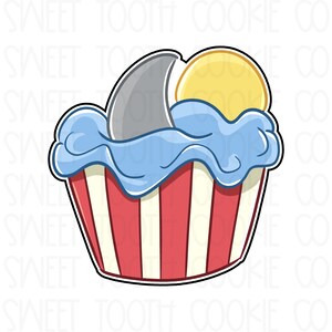 May include: A red and white striped cupcake with blue frosting and a gray shark fin sticking out of the frosting. The cupcake is topped with a yellow circle.