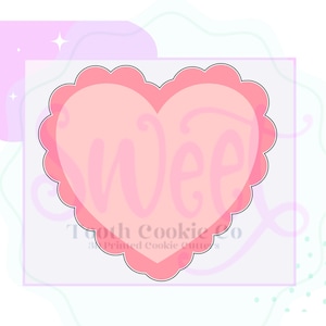 May include: A pink heart-shaped cookie cutter with a scalloped edge and the word "sweet" written inside. The cutter is on a white background.