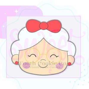 May include: A cookie cutter in the shape of a smiling woman's face with white hair, a red bow, and gold-rimmed glasses. The face has rosy cheeks and red earrings. The text "Tooth Cookie Co." and "3D Printed Cookie Cutters" is visible.