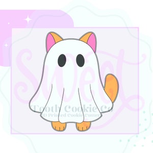 May include: A white ghost cookie cutter with orange cat ears and feet. The ghost has two black eyes and a pink outline around the ears. The cookie cutter is for making Halloween treats.