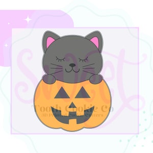 May include: A black cat with closed eyes is peeking out of a smiling orange pumpkin. The pumpkin has a traditional jack-o'-lantern face with a wide grin and triangular eyes. The text "Tooth Cookie Co. 3D Printed Cookie Cutters" is printed below the pumpkin.