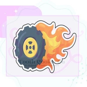 May include: A black tire with a yellow rim is on fire. The tire is outlined in white and the flames are orange and yellow.