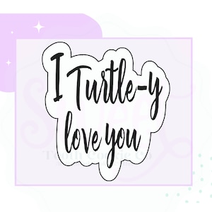 May include: A black and white cookie cutter in the shape of a cloud with the text "I Turtle-y love you" inside.