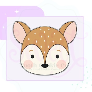 May include: A brown and white deer face cookie cutter with black eyes and a black nose. The cookie cutter is outlined in black.