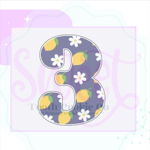 May include: A purple cookie cutter shaped like the number 3. The cutter is decorated with a pattern of lemons and white daisies.