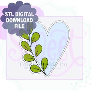 May include: A digital download file for a heart-shaped cookie cutter design. The heart is light blue with a white outline, and a green leafy branch is on the left side. The text "STL DIGITAL DOWNLOAD FILE" is at the top.