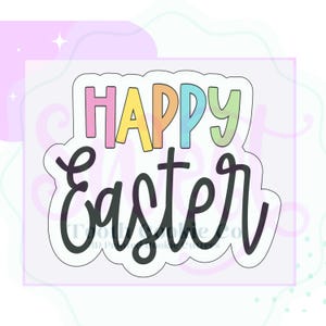 May include: A white cookie cutter with a black outline, featuring the text "Happy Easter" in a colorful, handwritten font.