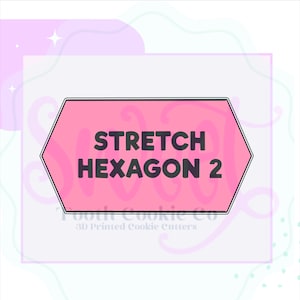 May include: Pink hexagonal cookie cutter with the text "STRETCH HEXAGON 2" in black. The cutter is on a white background with pink and blue abstract shapes.