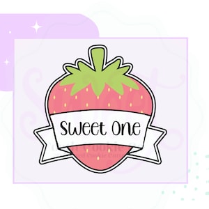 May include: A red and green strawberry cookie cutter with a white banner that says "Sweet One".