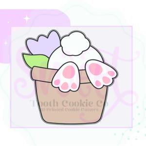 May include: A white bunny with pink feet and a fluffy tail is sitting in a brown flower pot. The bunny has a purple flower on its head and green leaves around its neck. The pot has the text "Tooth Cookie Co. 3D Printed Cookie Cutters" on the side.