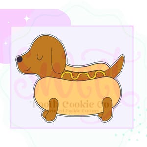 May include: A cartoon-style cookie cutter in the shape of a dachshund hot dog. The dog is brown with a yellow hot dog bun and mustard. The cutter is on a light purple background with the text "Tooth Cookie Co" printed on the bottom.