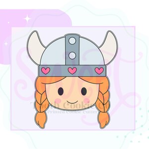 May include: A cookie cutter in the shape of a cartoon Viking girl's face. The girl has orange braids, a gray helmet with horns, and pink heart accents. The text "Tooth Cookie Co. Printed Cookie Cutter" is at the bottom.
