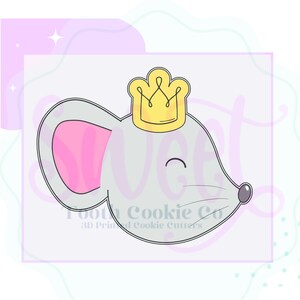 May include: A gray mouse cookie cutter with a pink ear and a yellow crown on its head. The cutter is designed for making cookies in the shape of a mouse.
