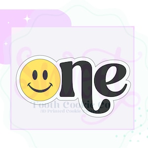 May include: A cookie cutter with the word "one" in black, with a yellow smiley face replacing the "o". The smiley face has black eyes and a curved mouth. The text is outlined in white.