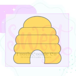 May include: A yellow beehive-shaped cookie cutter with a black outline. The cookie cutter has a rounded top and a rectangular base with an arched opening. The text "Tooth Cookie Co" and "3D Printed Cookie Cutters" is printed on the bottom.