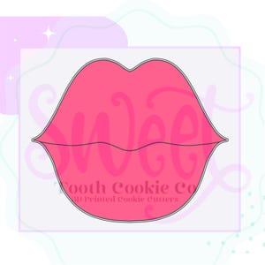 May include: Pink plastic cookie cutter shaped like a pair of lips. The cookie cutter is for making cookies and is 3D printed.