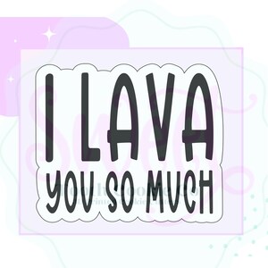 May include: A black and white cookie cutter with the phrase "I LAVA YOU SO MUCH" in a bold, rounded font. The text is inside a white, irregular-shaped border, set against a light purple background with decorative elements.