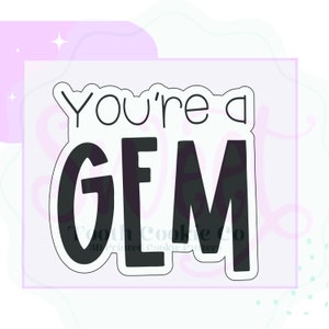 May include: A black and white cookie cutter with the text "You're a GEM".