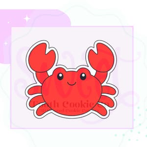 May include: A red crab-shaped cookie cutter with a white outline. The design features a central crab body with two raised claws, six legs, and a simple face with two black eyes and a small curved mouth, all rendered in a flat, graphic style.