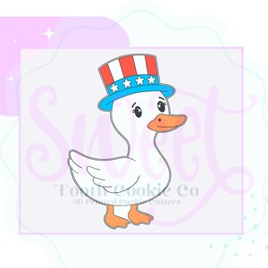 May include: A cartoon duck wearing a patriotic Uncle Sam hat with red, white, and blue stripes and stars. The duck has a white body, orange beak and feet, and is a cookie cutter design.
