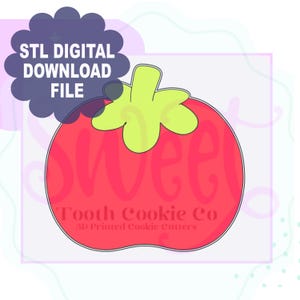 May include: A red and green 3D printed cookie cutter shaped like a strawberry. The text "Tooth Cookie Co. 3D Printed Cookie Cutters" is on the cutter.