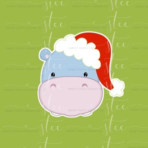 May include: A cartoon hippopotamus wearing a red Santa hat with white trim. The hippo has a light blue body, pink nose, and black eyes.